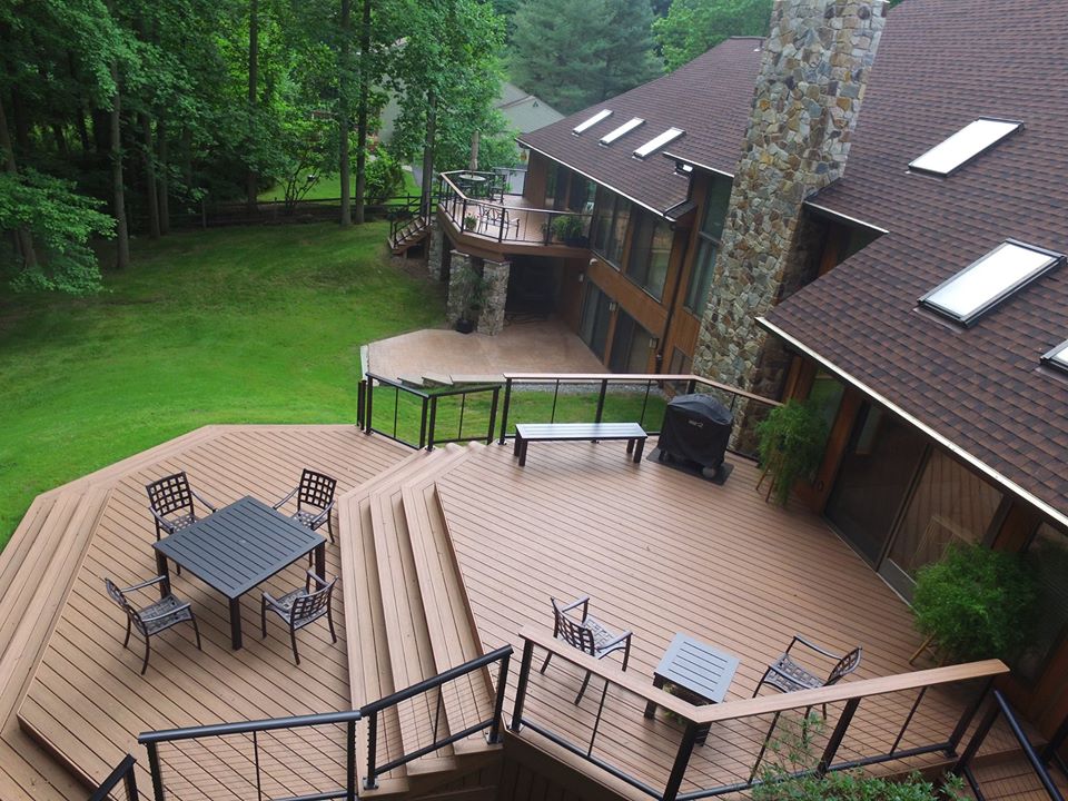 Large deck with steps down to a lower deck and grass area