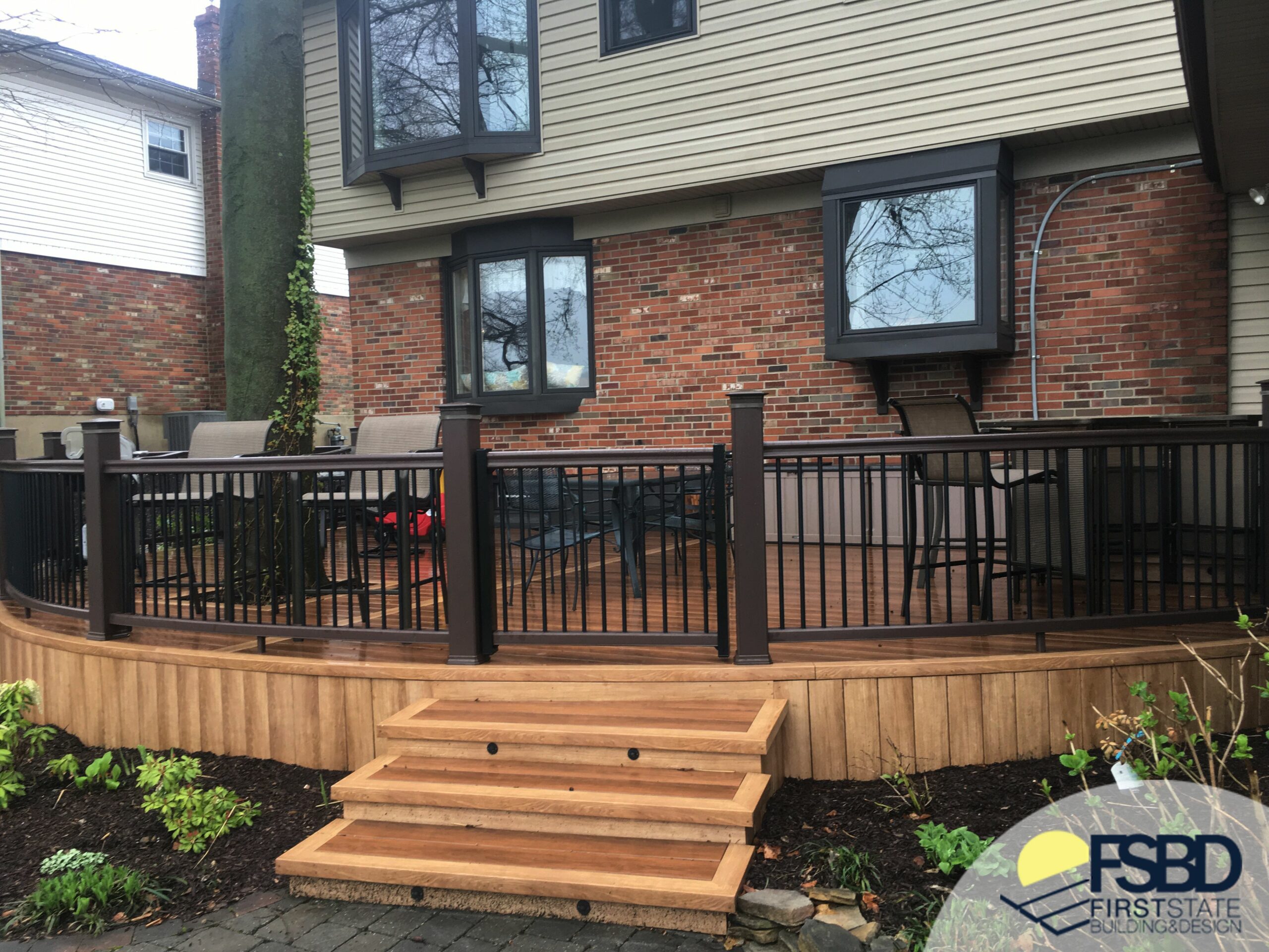 Curved deck with stairs and railing