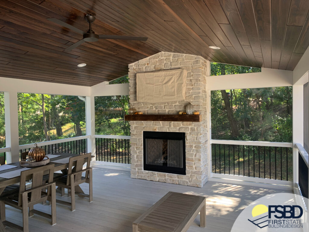 Outdoor stone fireplace under covered porch