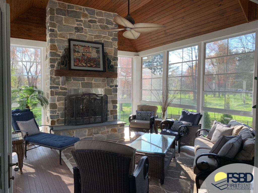 Outdoor stone fireplace in sunroom