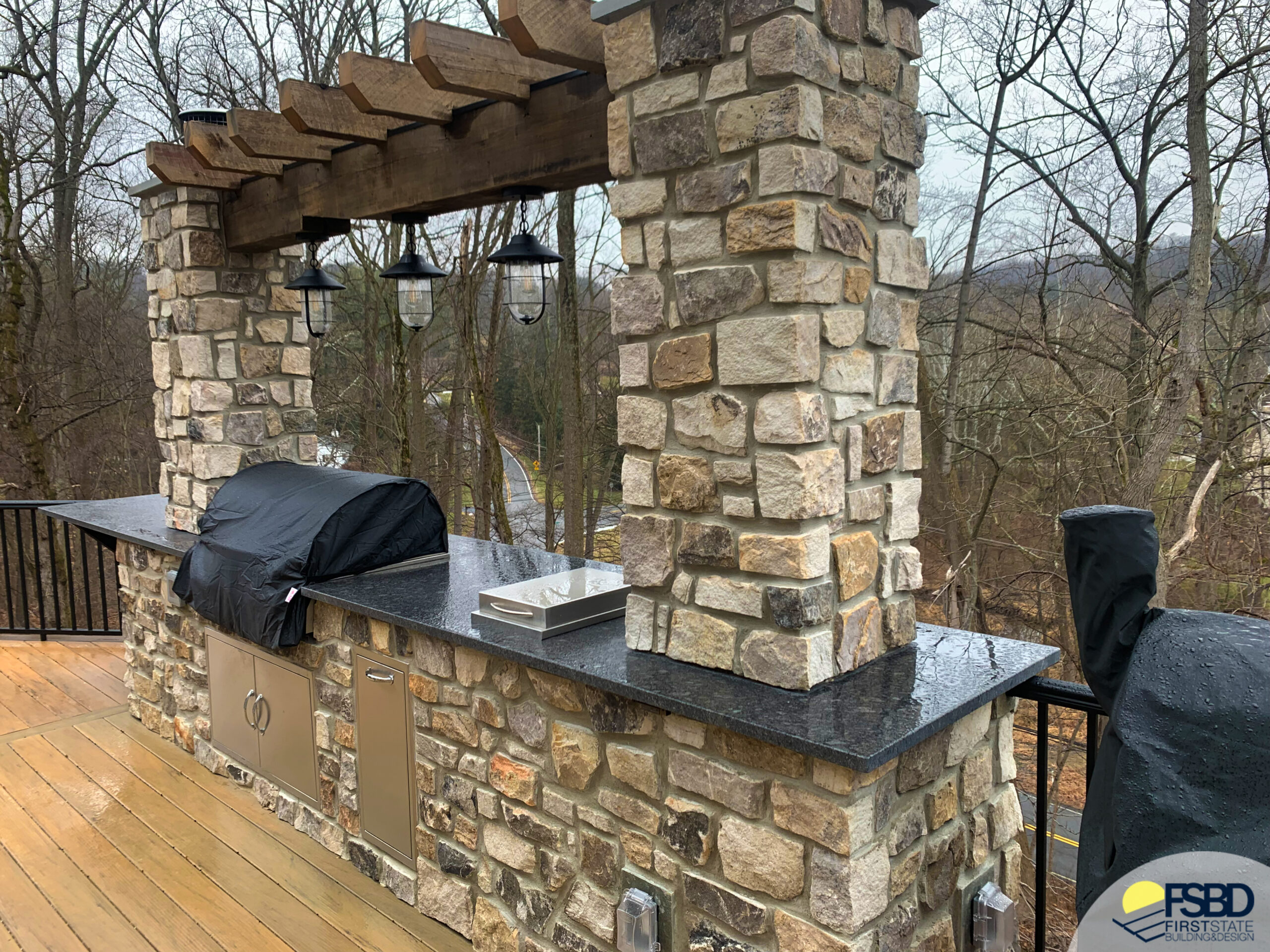Stone outdoor kitchen with black granite countertop