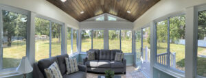 Large enclosed sunroom overlooking backyard